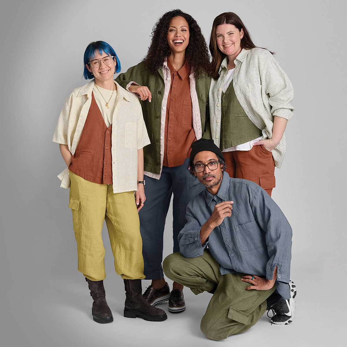 group of four people in colorful linen clothing