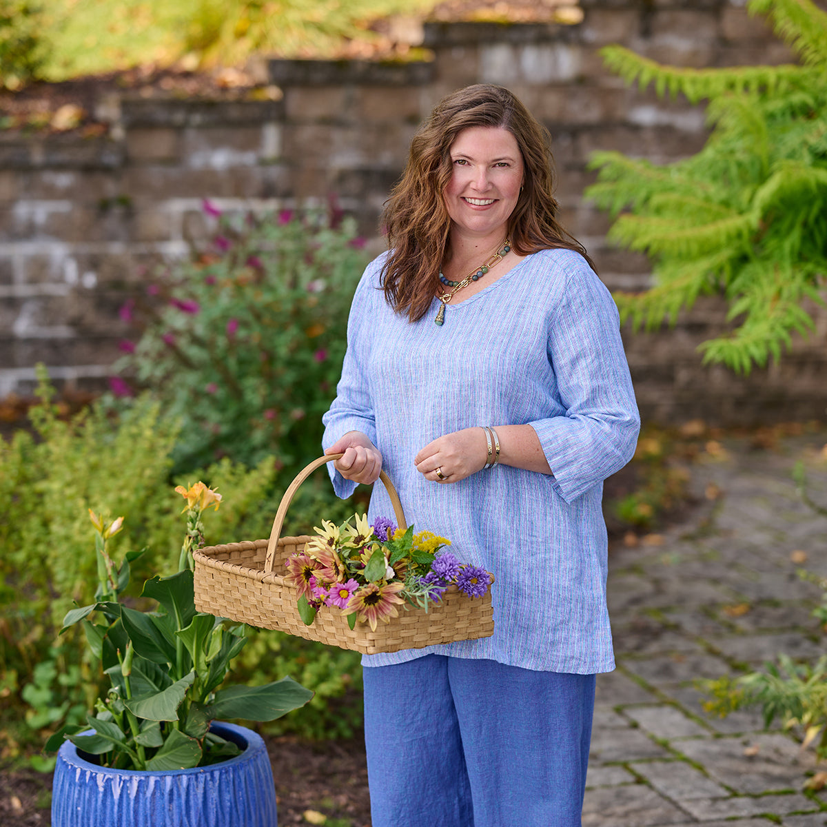 woman outside wearing blue linen clothing