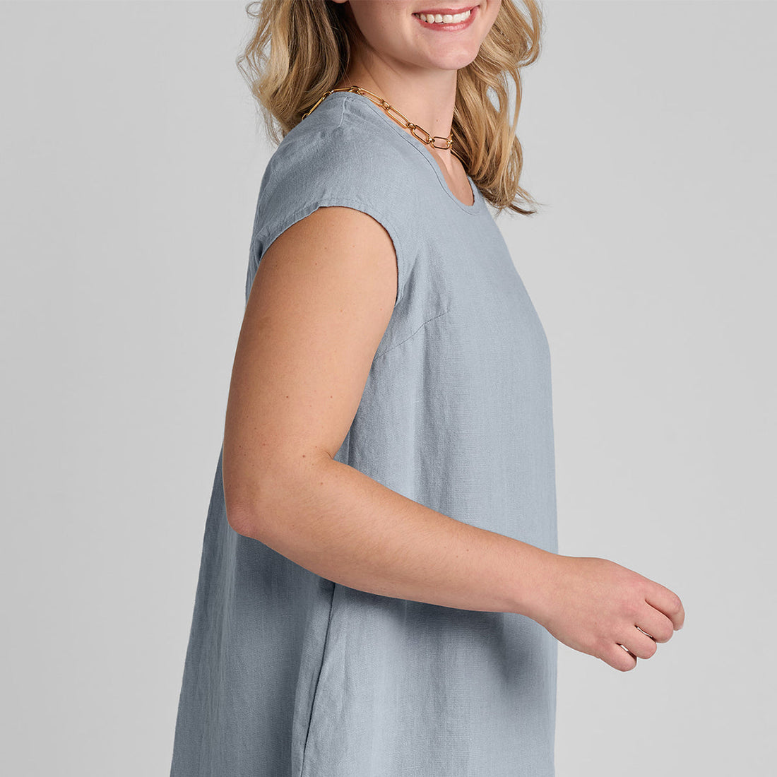 close up shot of side view of blue linen dress