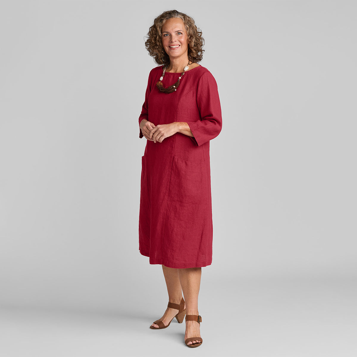 woman wearing red linen shift dress