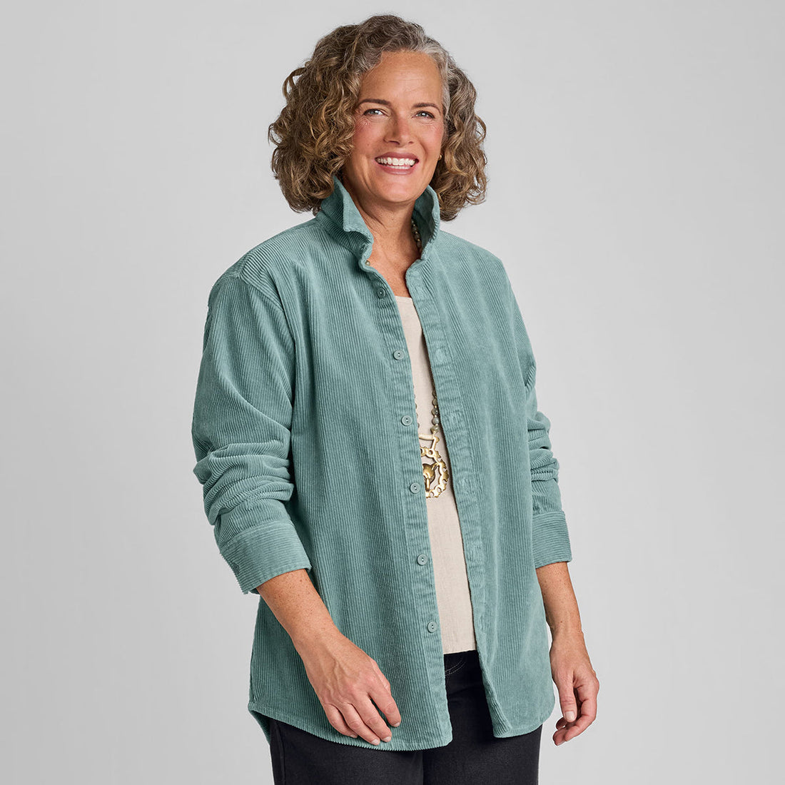 close up photo of a woman wearing a blue corduroy oversized shirt