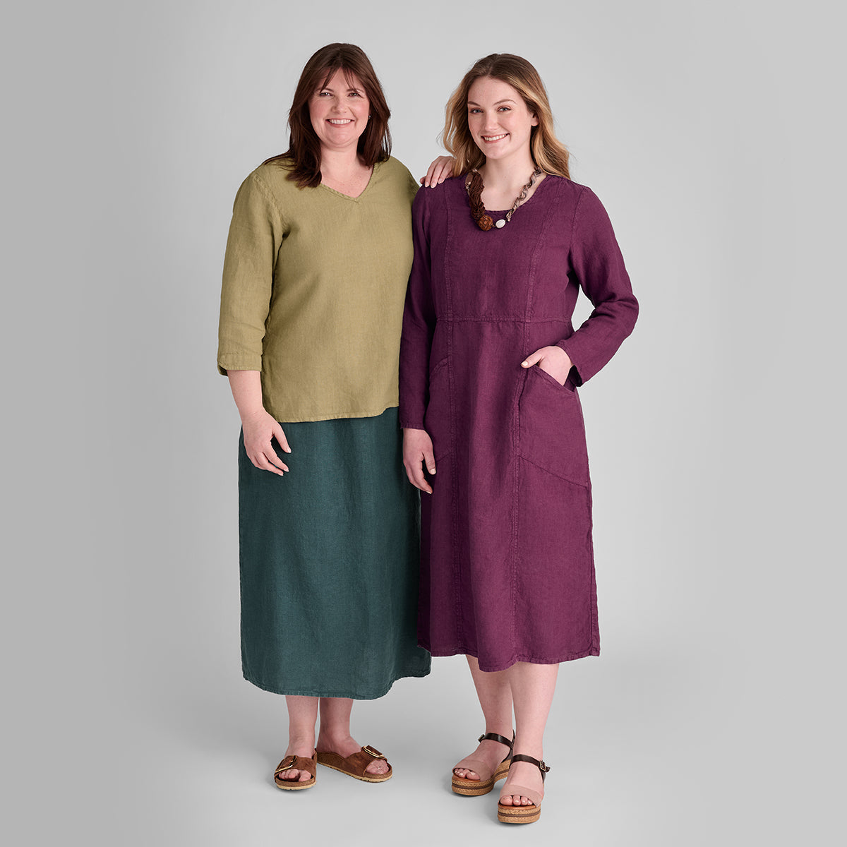 two women wearing FLAX linen clothing in green and purple