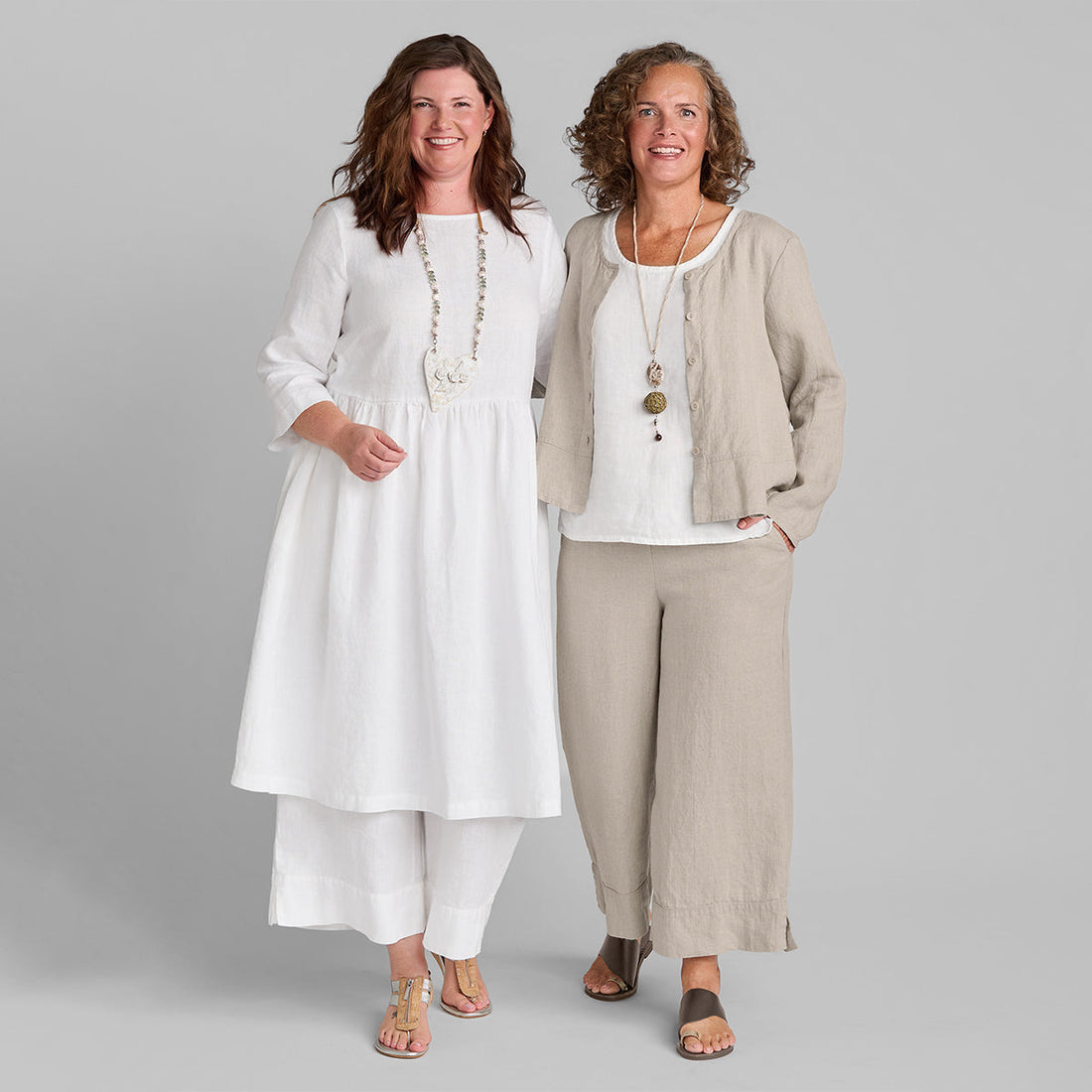 two women wearing natural and white linen clothing