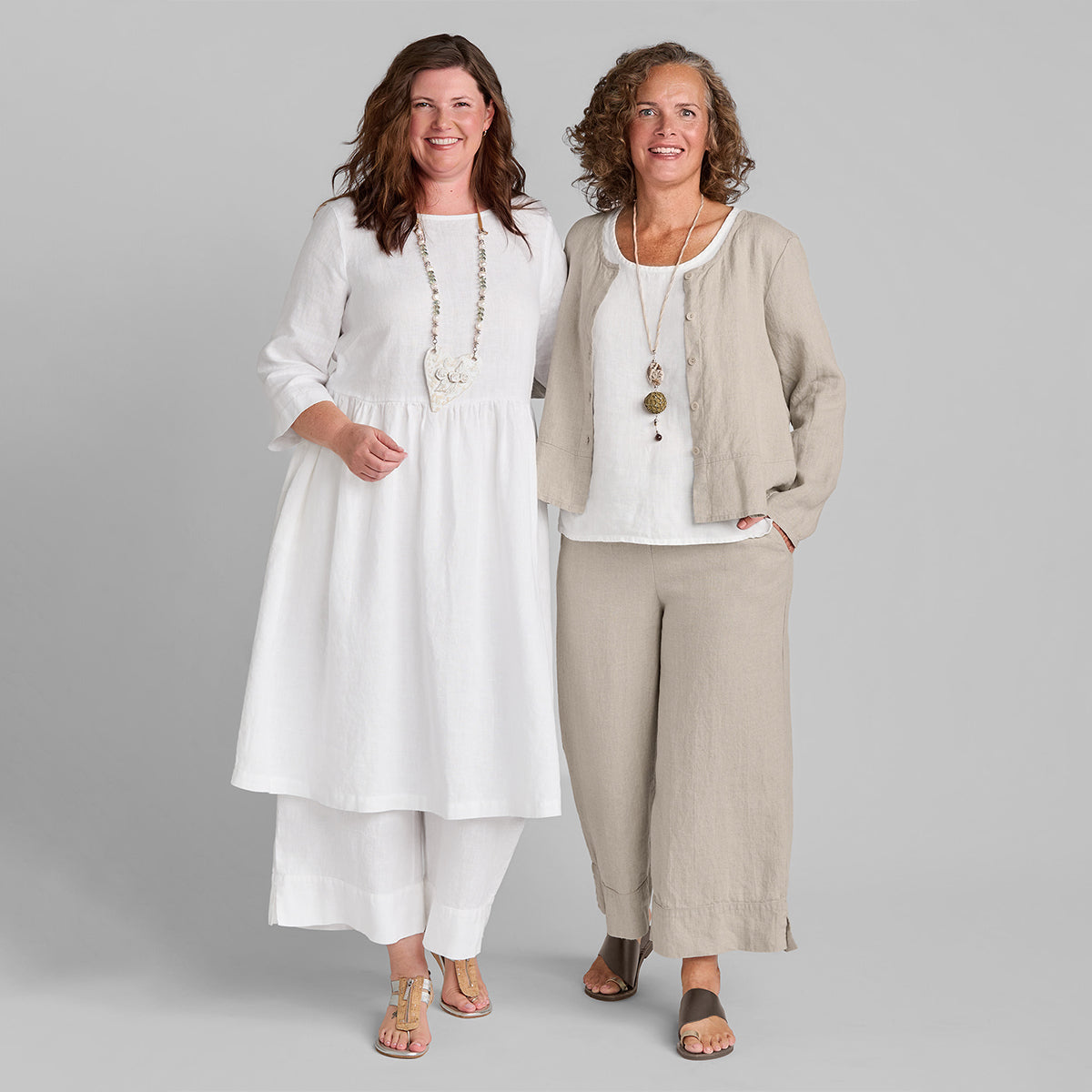 two women wearing natural and white linen clothing