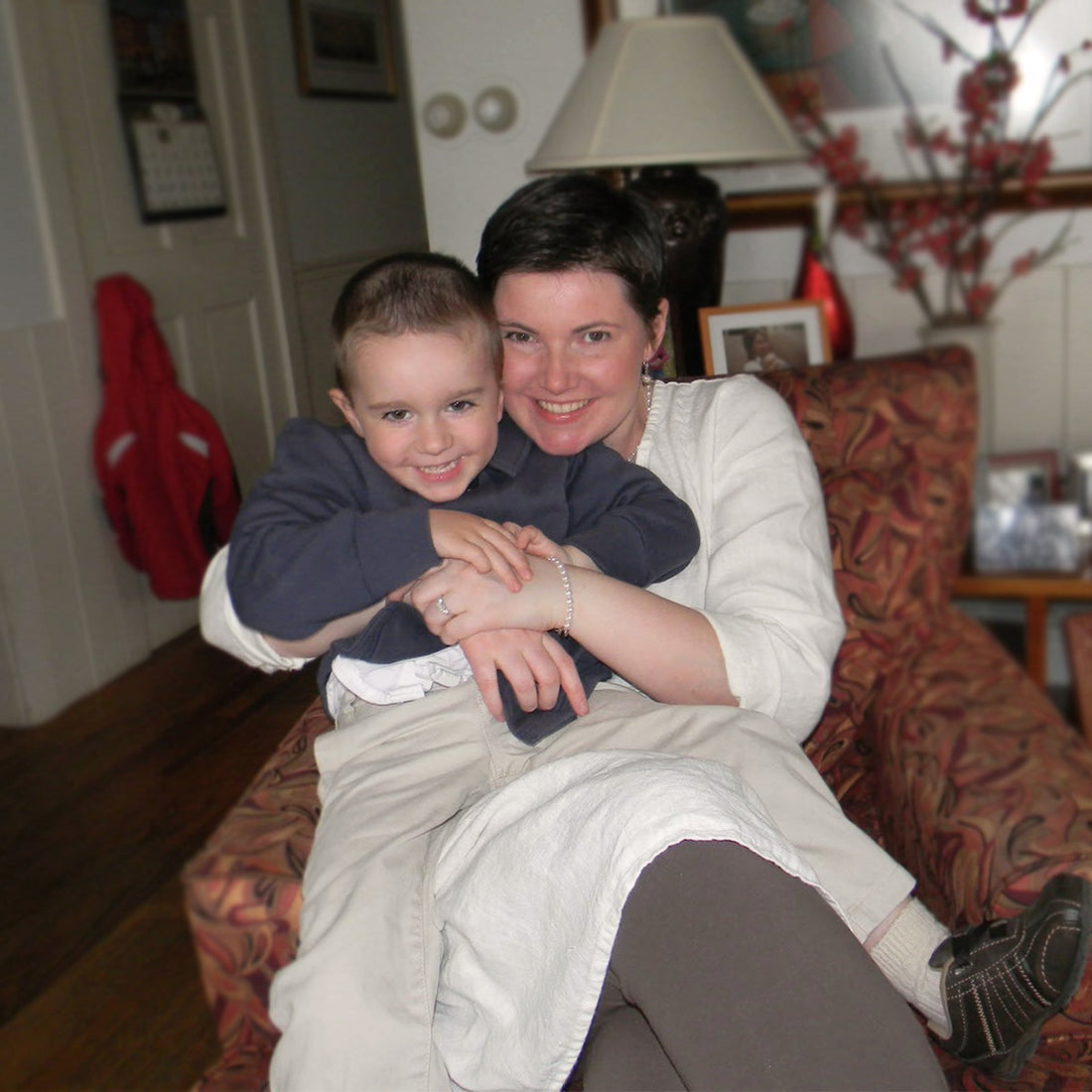woman wearing flax hugging a young child