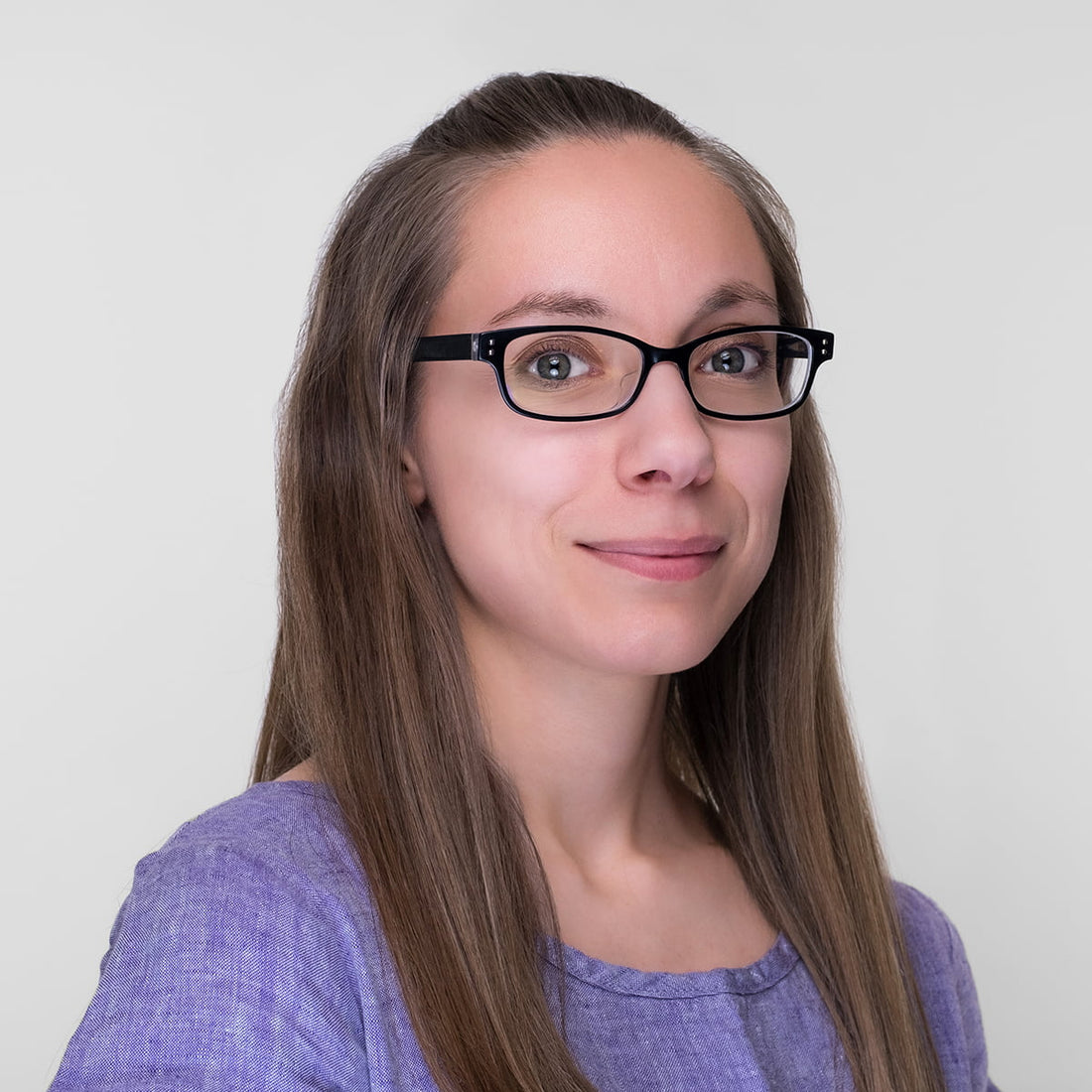 headshot of young woman in purple linen top