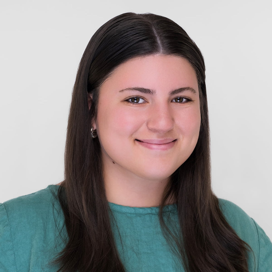 headshot of woman in green linen top