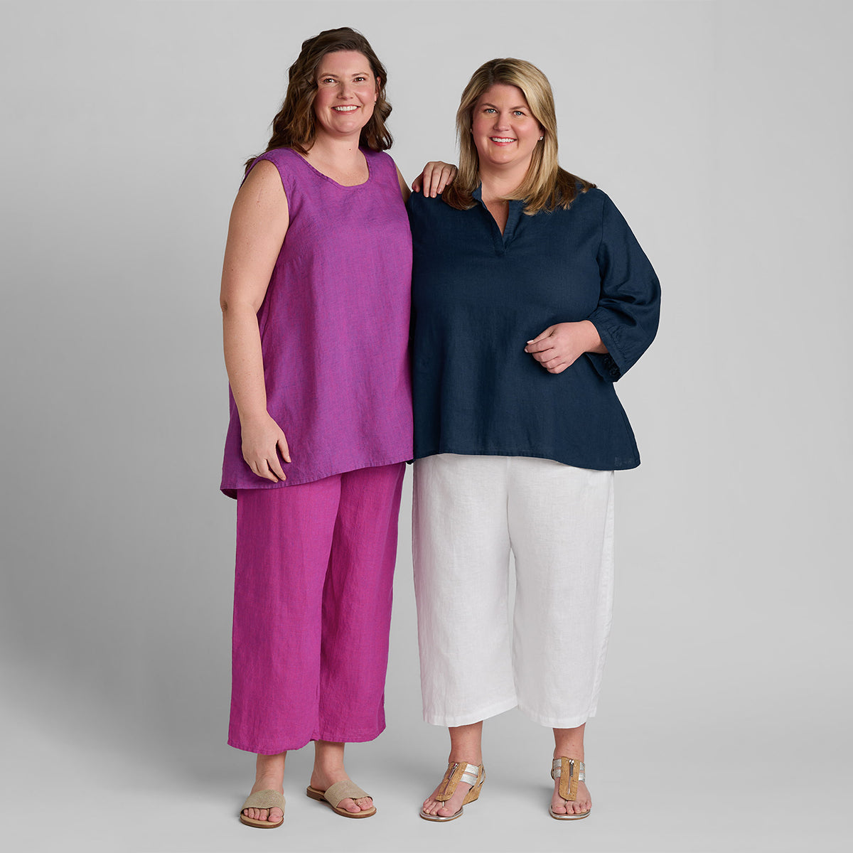 two women standing next to each other in colorful FLAX linen clothing