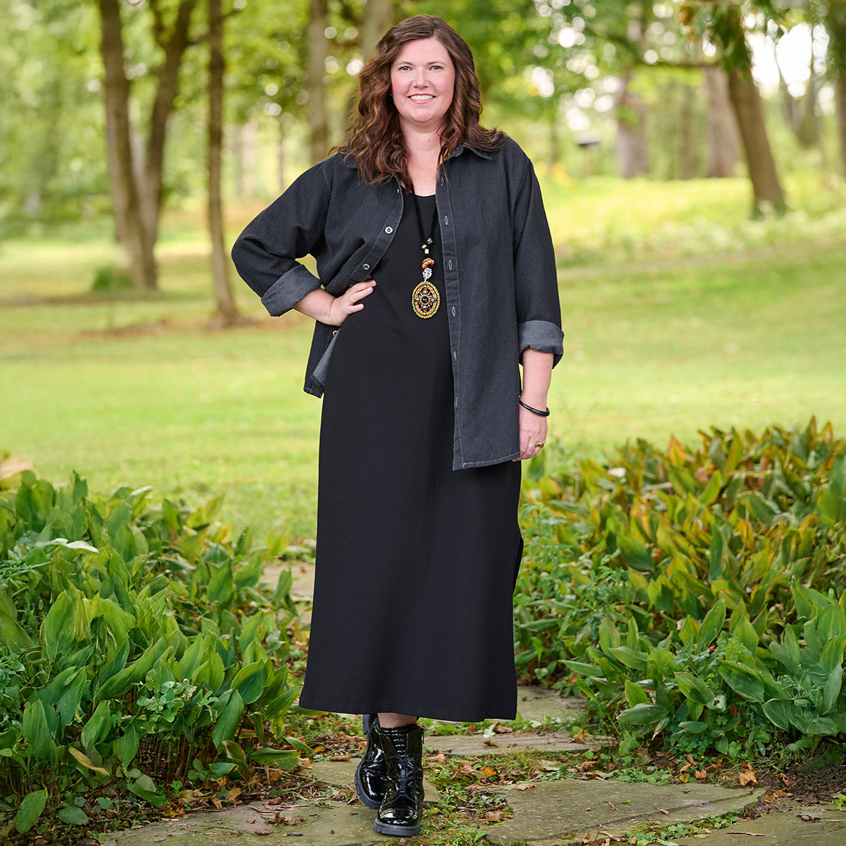 woman outside wearing black maxi dress with linen blend denim shirt