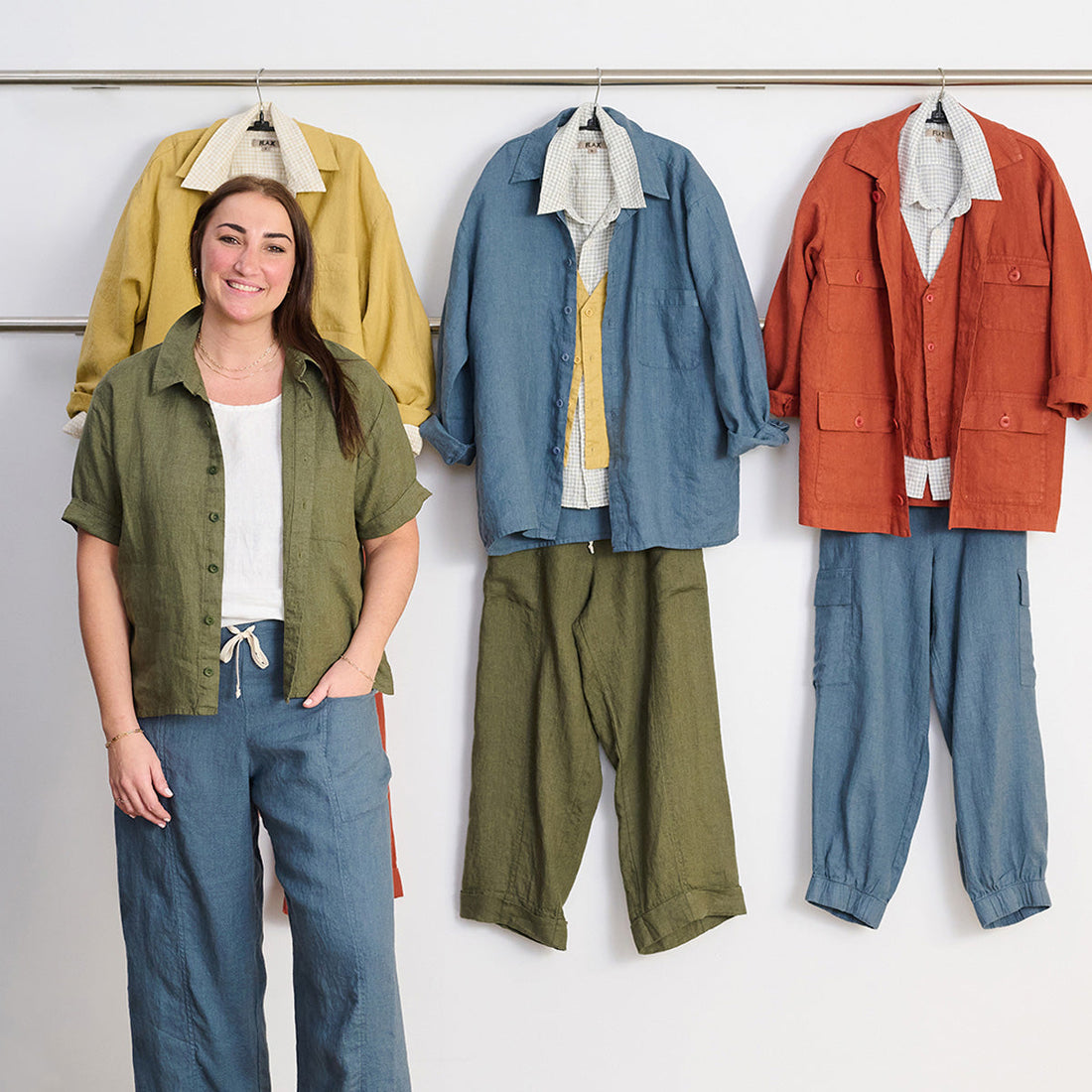 woman in front of a rack of colorful linen clothing