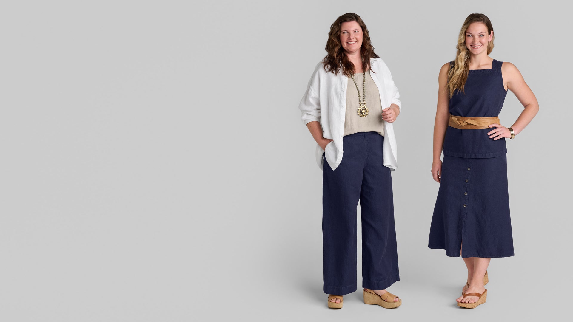 Two women standing in linen/cotton denim outfits in blue