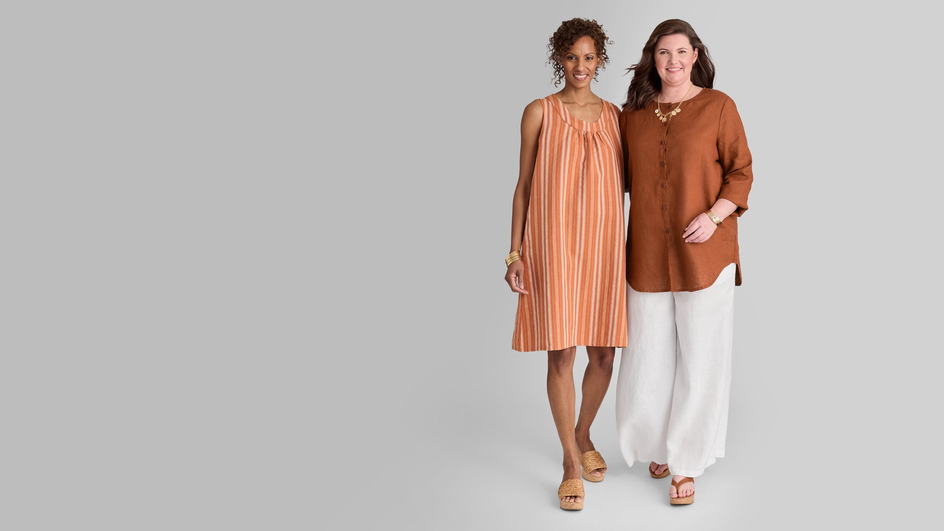 Two women in brown and orange Flax linen outfits