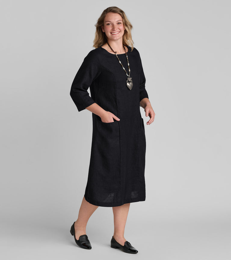 Woman in black linen dress wearing Flax clothing brand