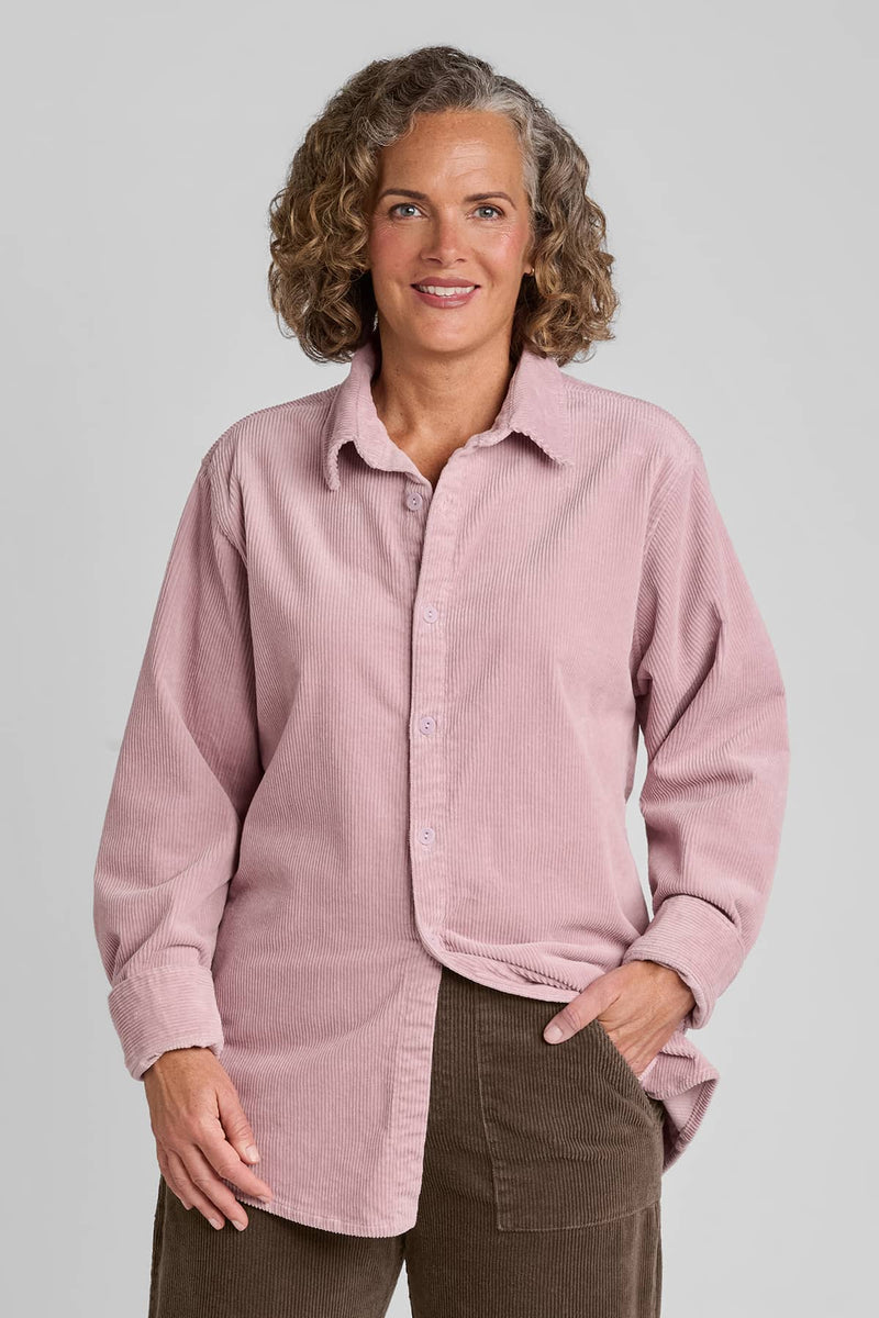 Woman in pink corduroy shirt with brown corduroy pants