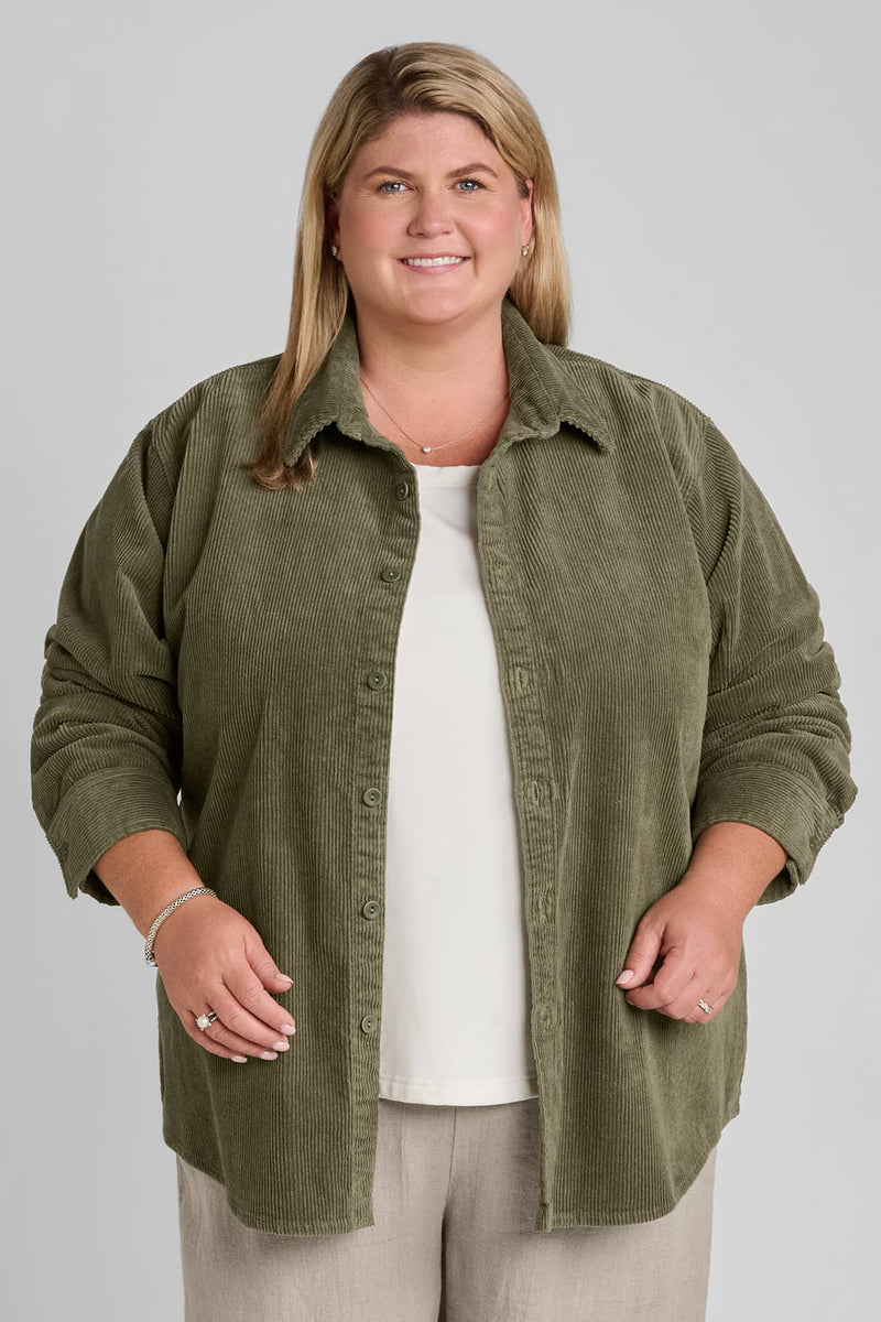 Woman in green corduroy shirt with beige linen pants