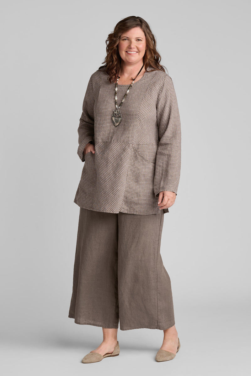 Woman in FLAX clothing brand brown linen shirt and brown linen wide leg pants