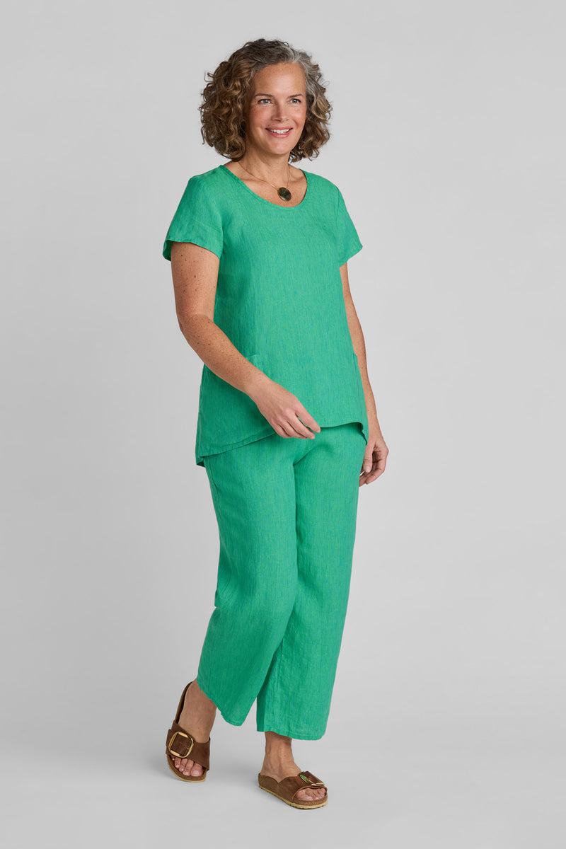 Woman in green linen short sleeve shirt and green linen pants