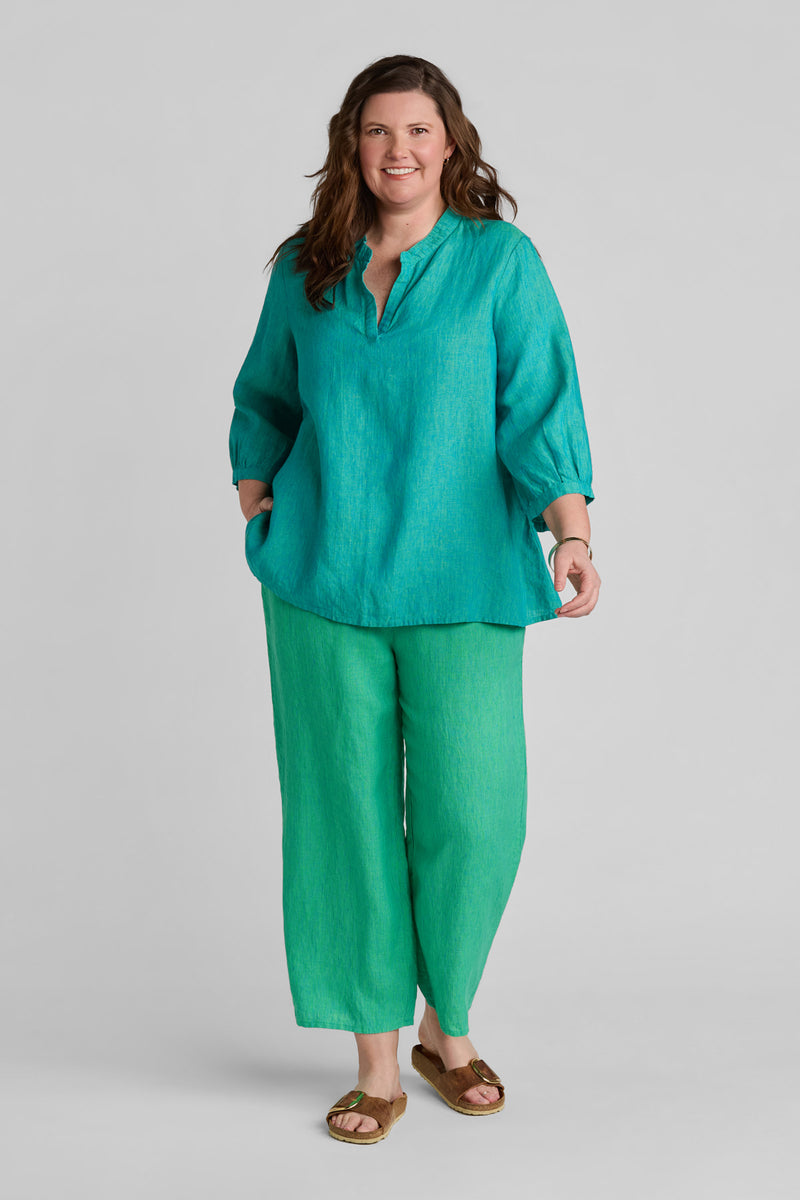 Woman in blue linen shirt and green linen pants