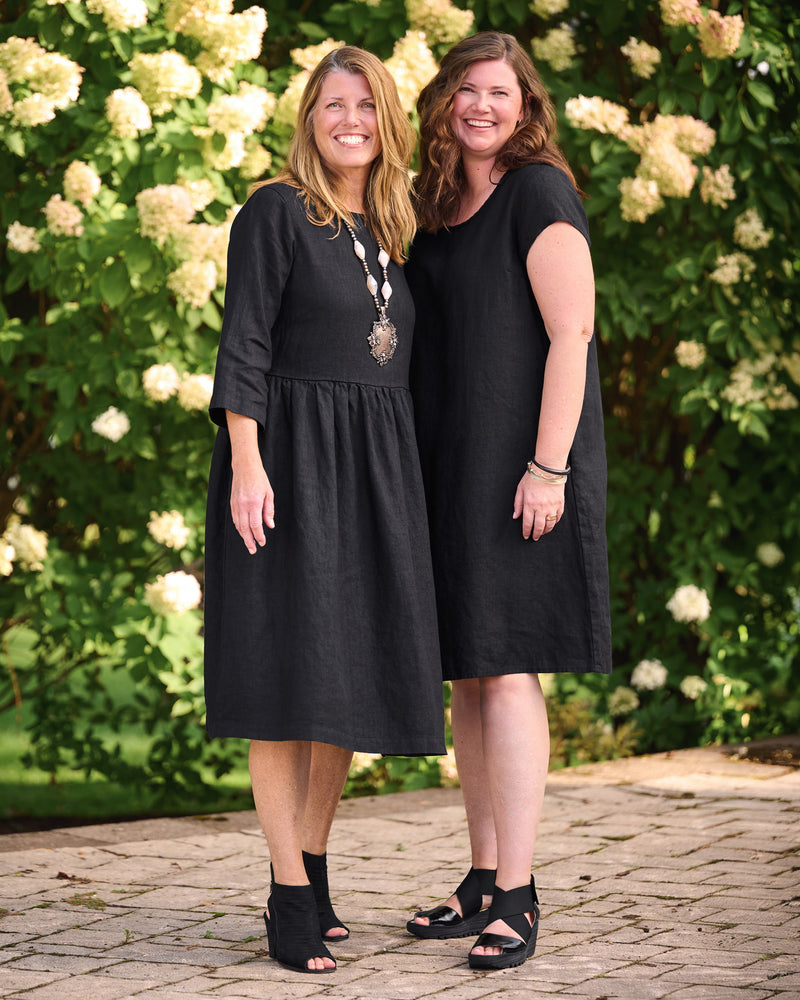 Two women in black linen dresses