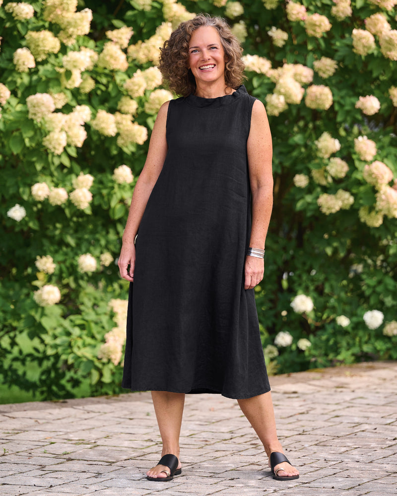 Woman in sleeveless black linen dress
