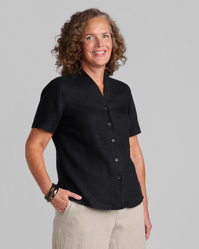 Woman in a black linen short sleeve shirt