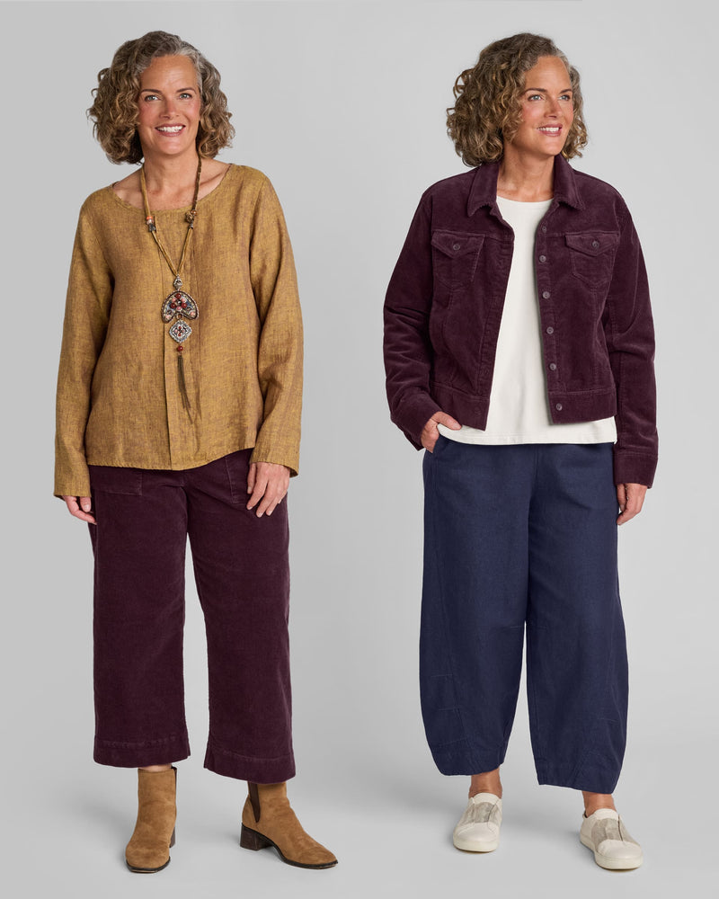 One woman in a brown linen long sleeve shirt with red corduroy pants and another woman in a red corduroy jacket with blue linen/cotton blend pants