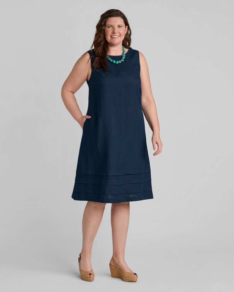 Woman in blue linen sleeveless dress