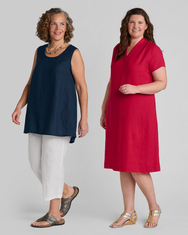 Woman in blue linen tank and white linen pants and another woman in a red linen dress