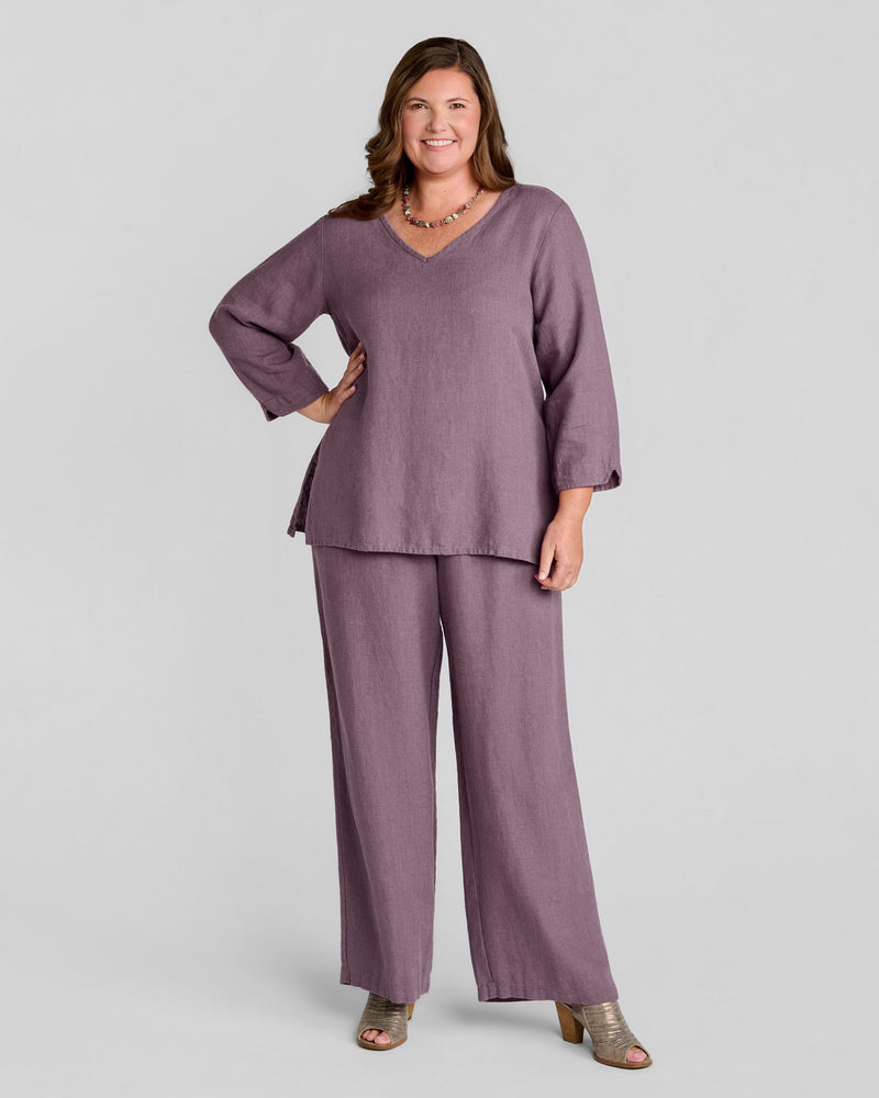 Woman in purple v neck long sleeve linen pullover with purple full length linen pants