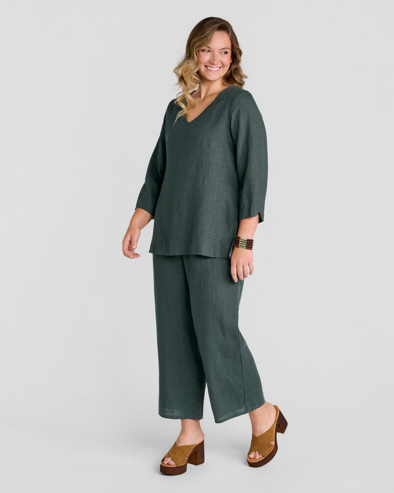Woman in green long sleeve linen pullover with green full length linen pants