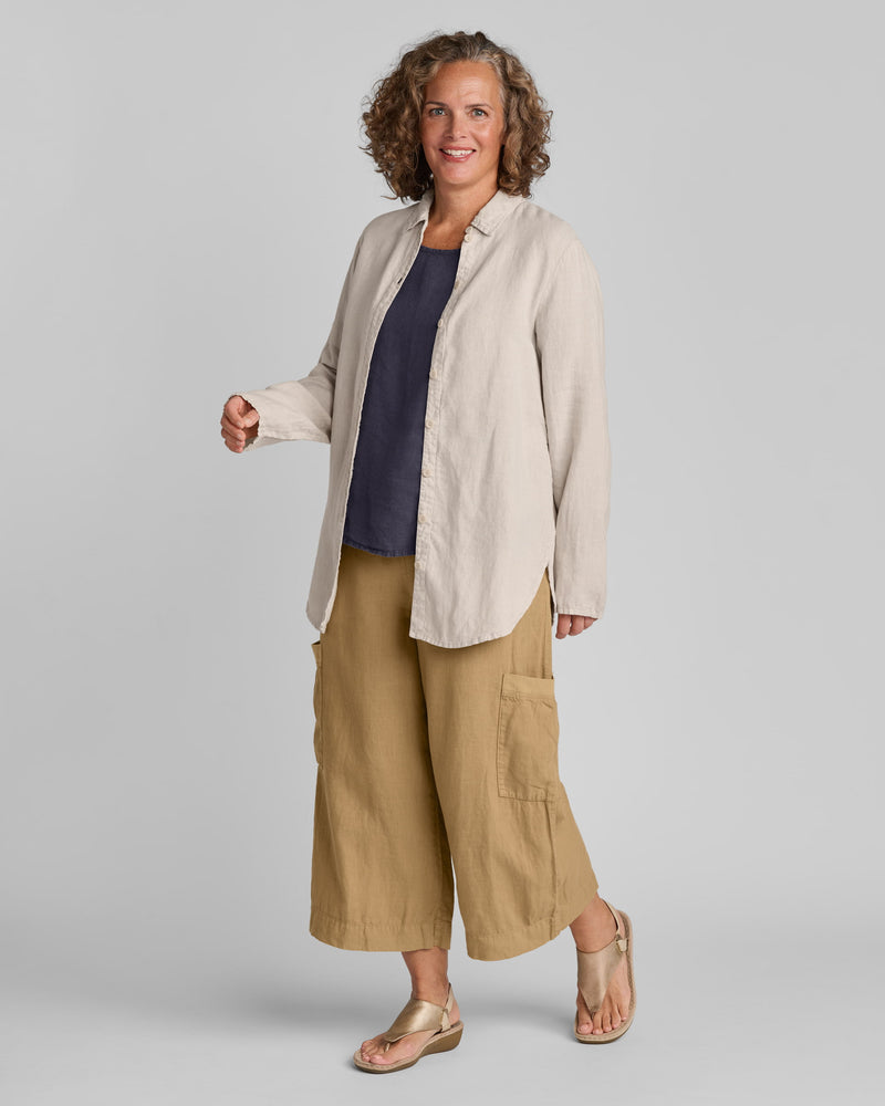Woman in FLAX linen clothing brand tan, blue, and brown linen outfit