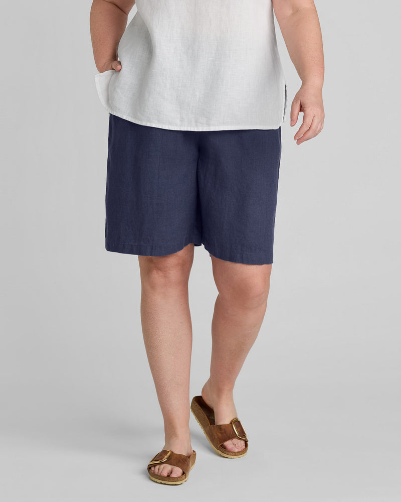 Woman in blue linen shorts