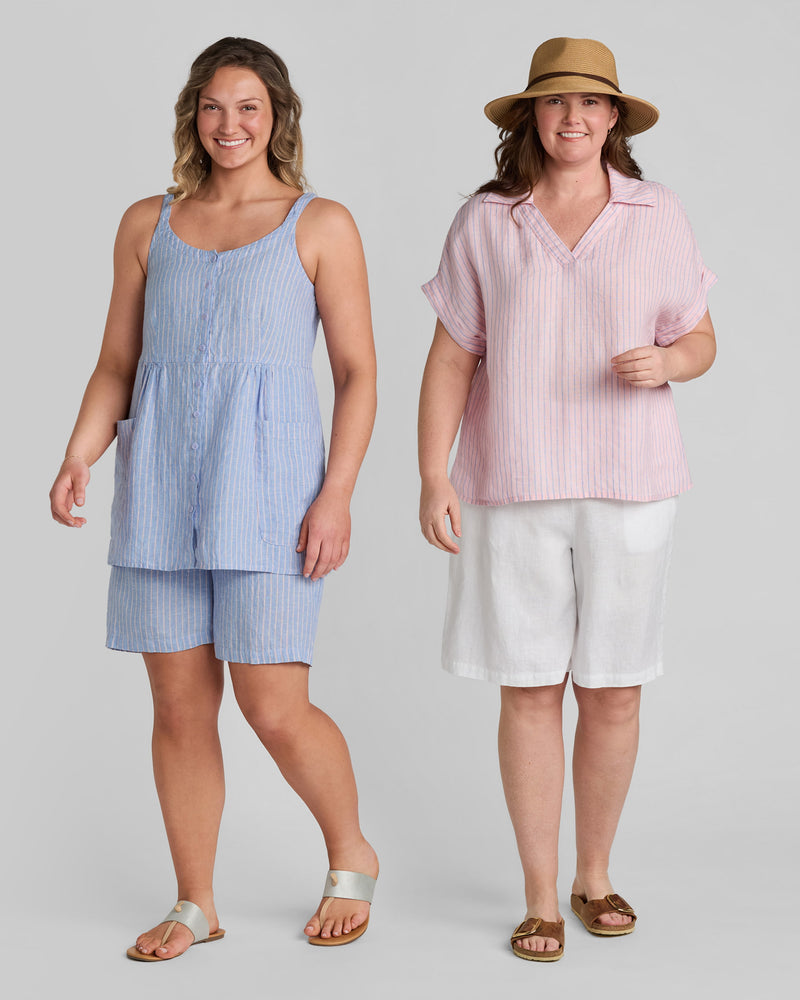 Woman in blue linen shorts and blue linen tank top and another woman in pink linen tee shirt and white linen shorts