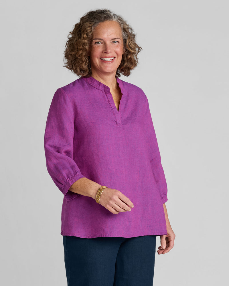 Woman in purple 3/4 sleeve linen top and blue linen pants