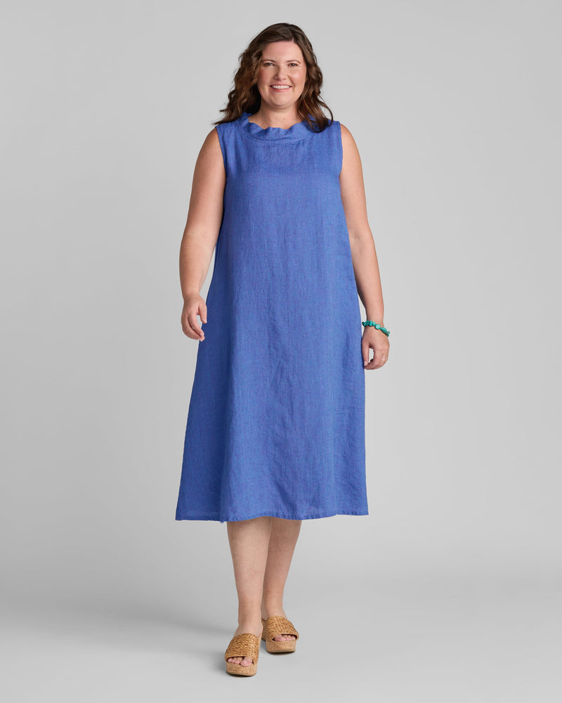 Woman in blue linen sleeveless dress with standup collar