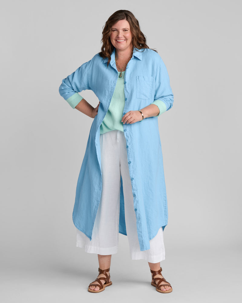 Woman in blue linen shirtdress with white linen pants