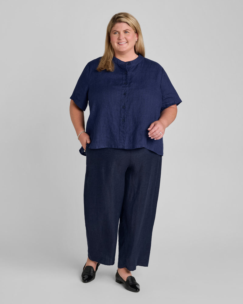 Woman in a blue short sleeve linen shirt with blue linen pants
