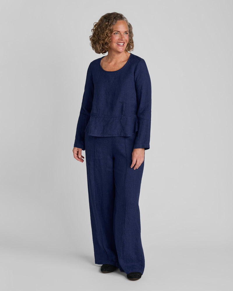Woman in a blue long sleeve linen shirt with blue linen pants