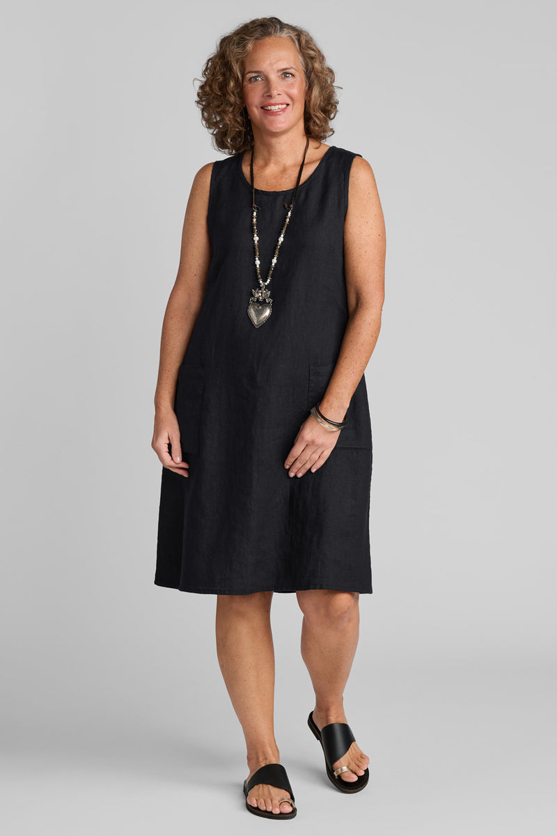 Woman in black linen sleeveless dress