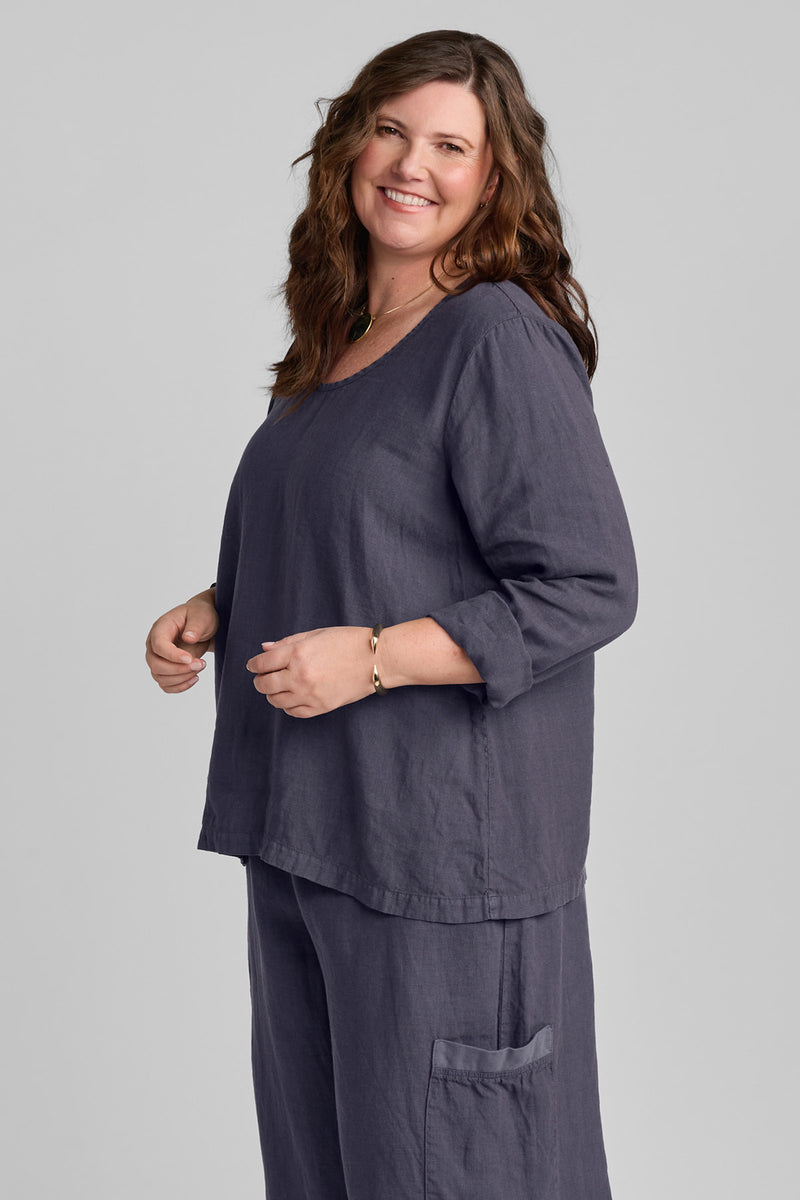 Woman in blue linen pants and blue linen shirt