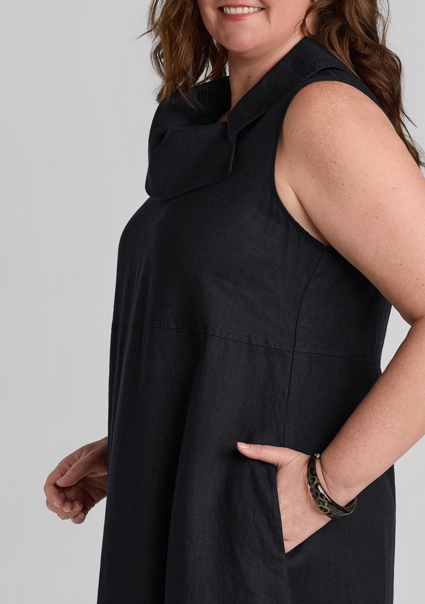 side view of women's black linen dress with pockets