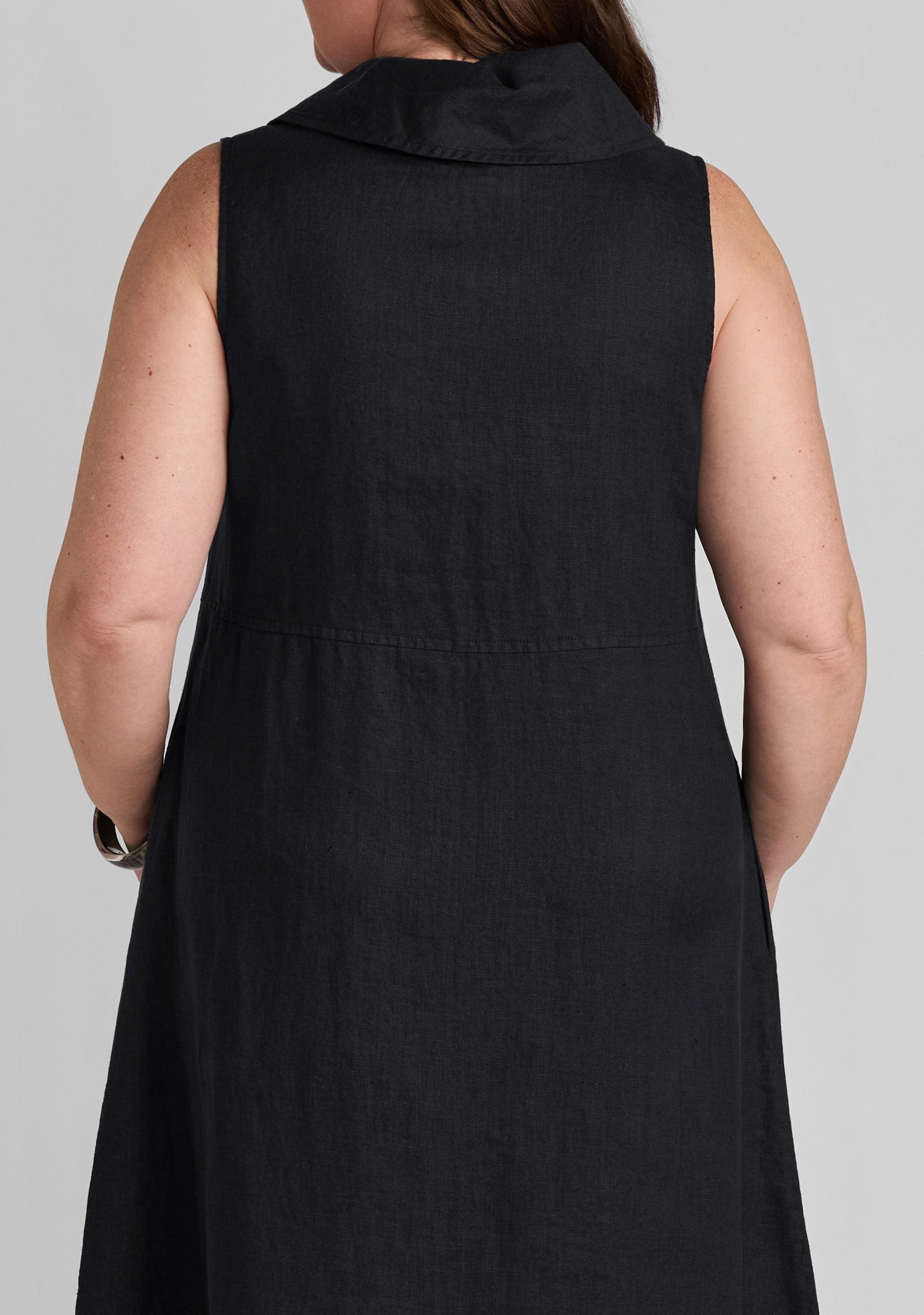 back view of seaming details on women's black linen dress