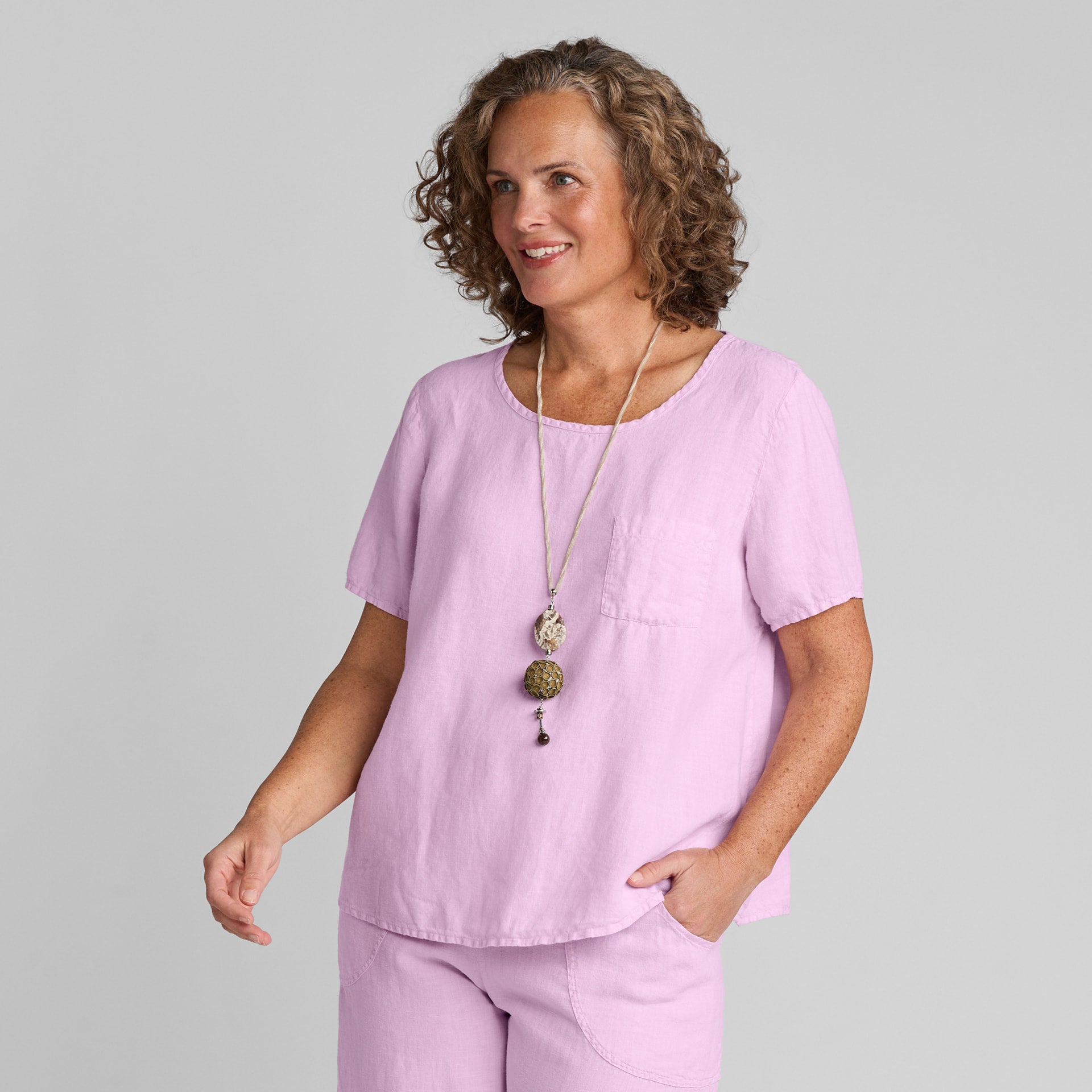 Woman in pink linen tee shirt