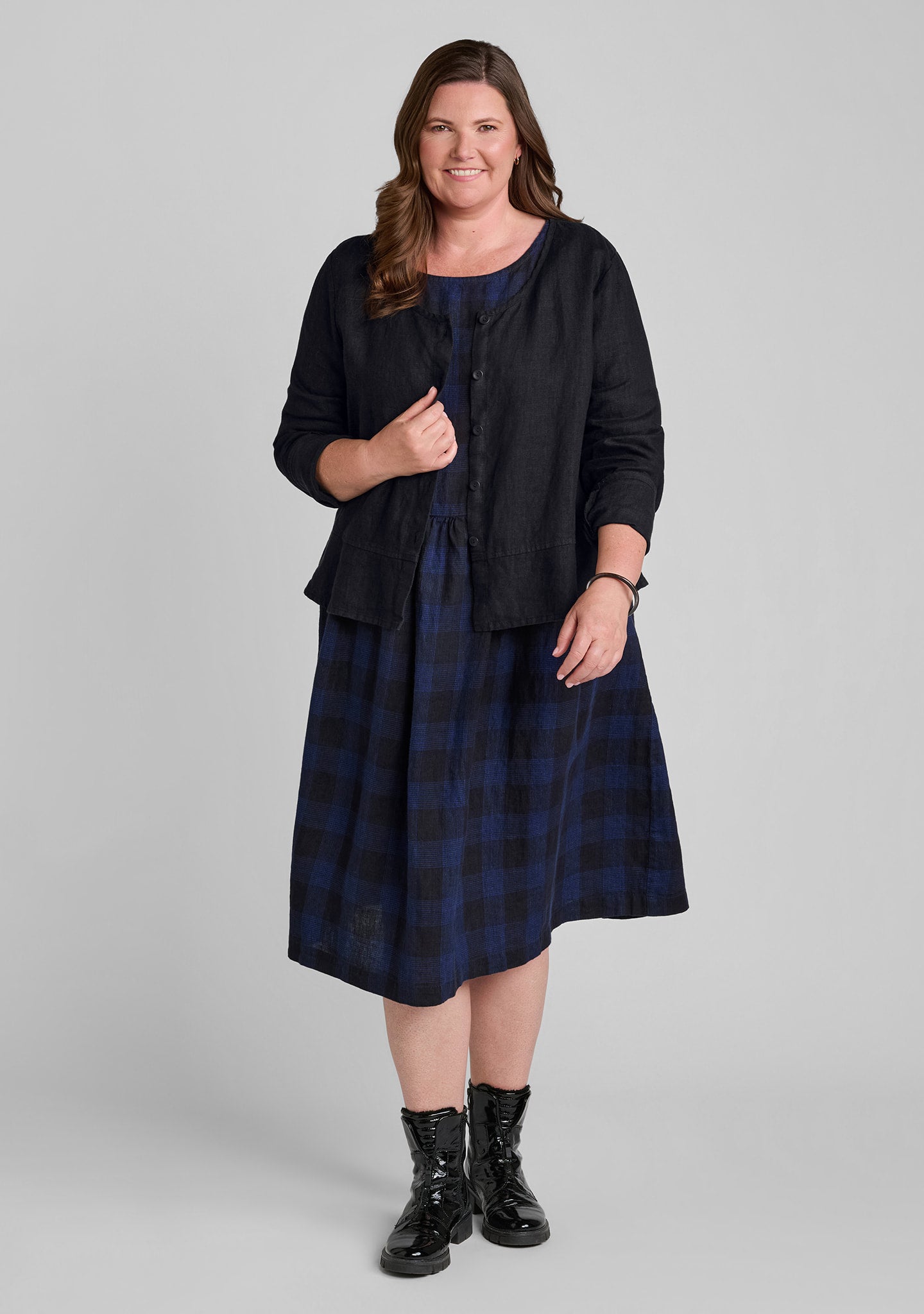 FLAX linen blouse in black over linen dress in plaid