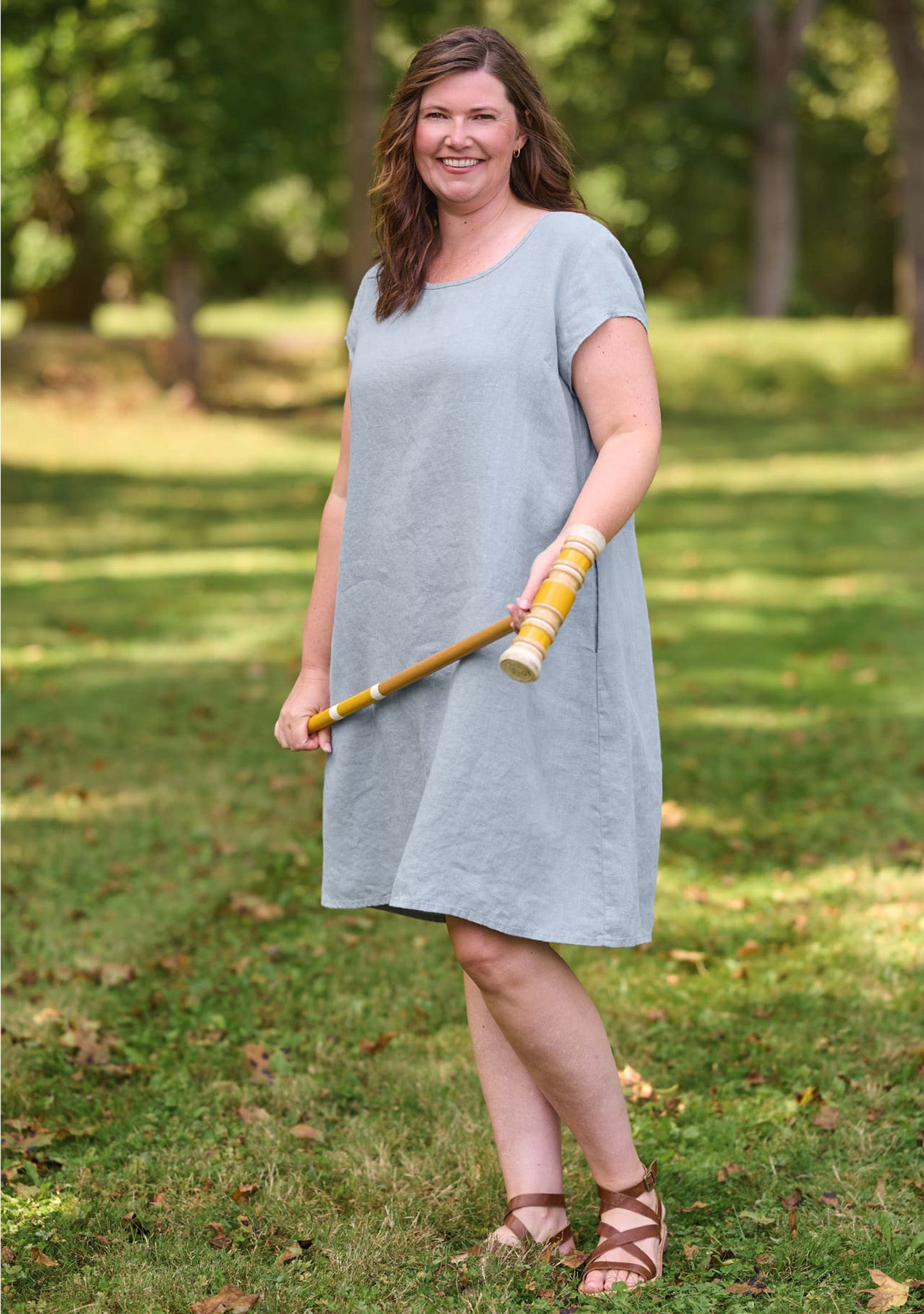 woman outdoors wearing dress in light blue green shade