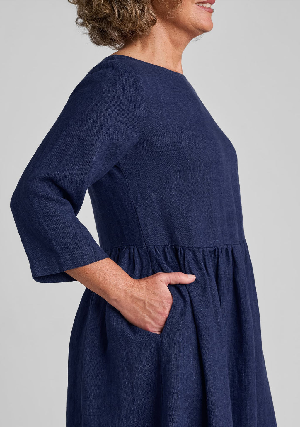 side view of pockets, sleeve, and bust dart on dress