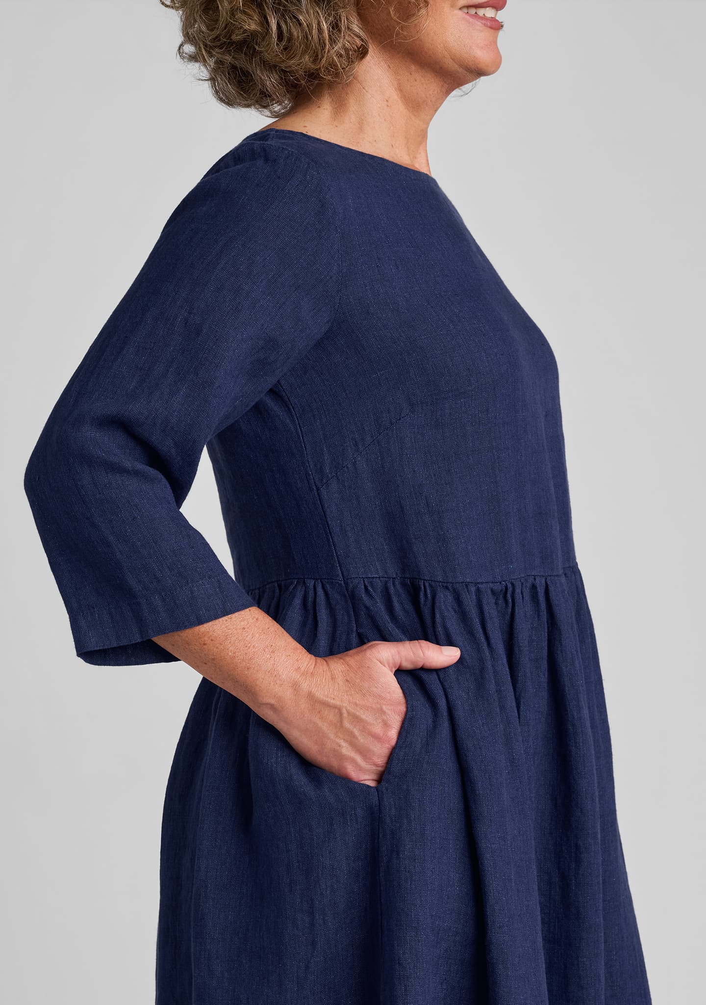 side view of pockets, sleeve, and bust dart on dress