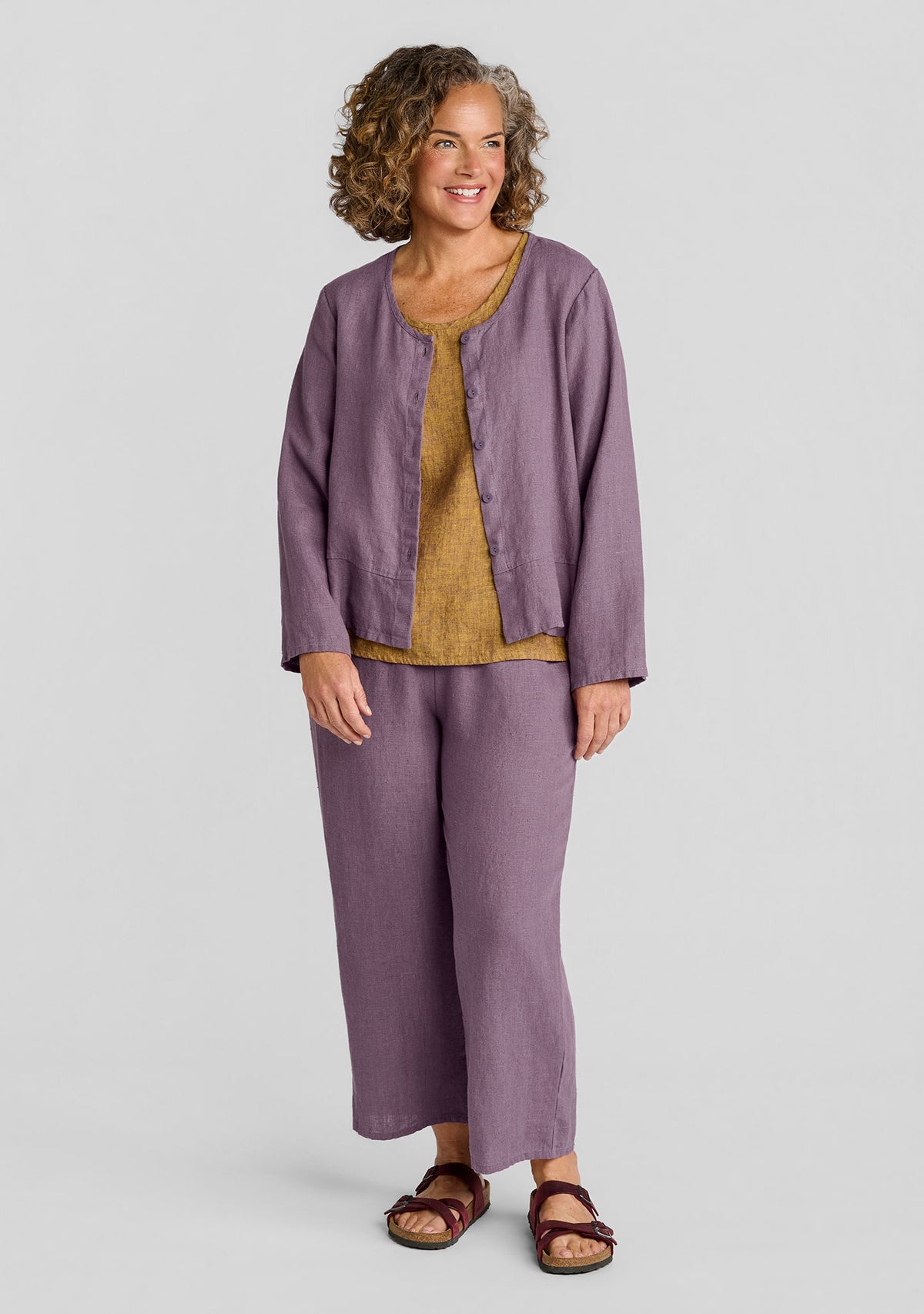 FLAX linen cardigan in purple over linen tank top in brown with cropped linen pants in purple
