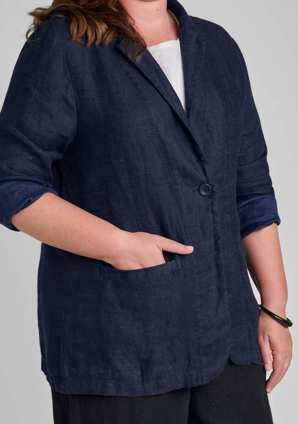 view of button detail and pocket on womens linen blazer in blue