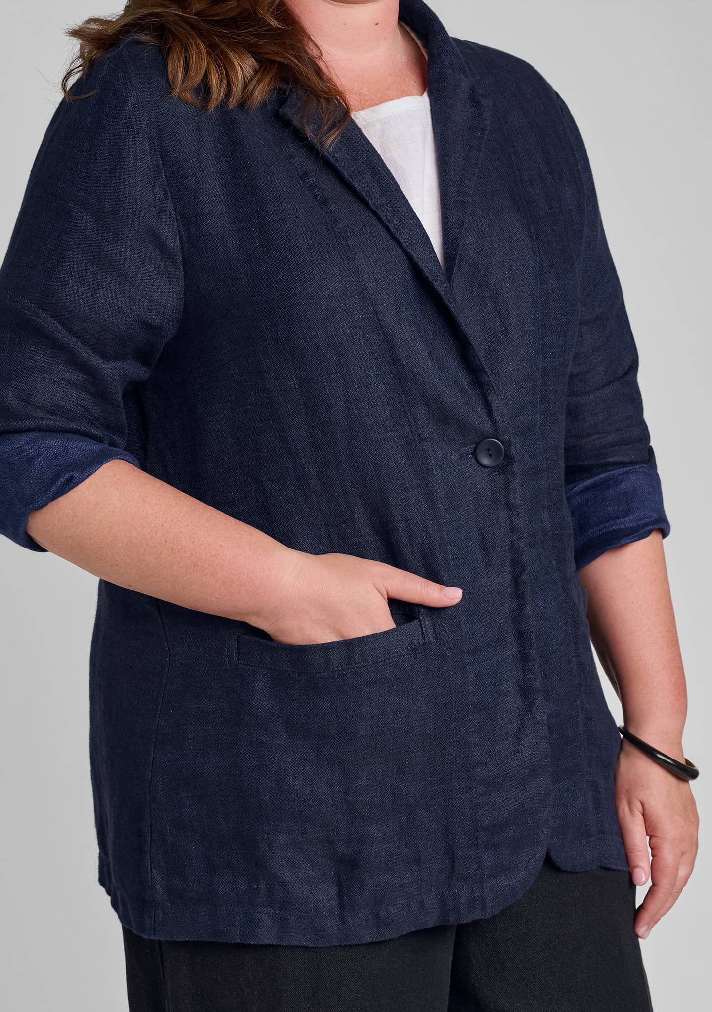 view of button detail and pocket on womens linen blazer in blue